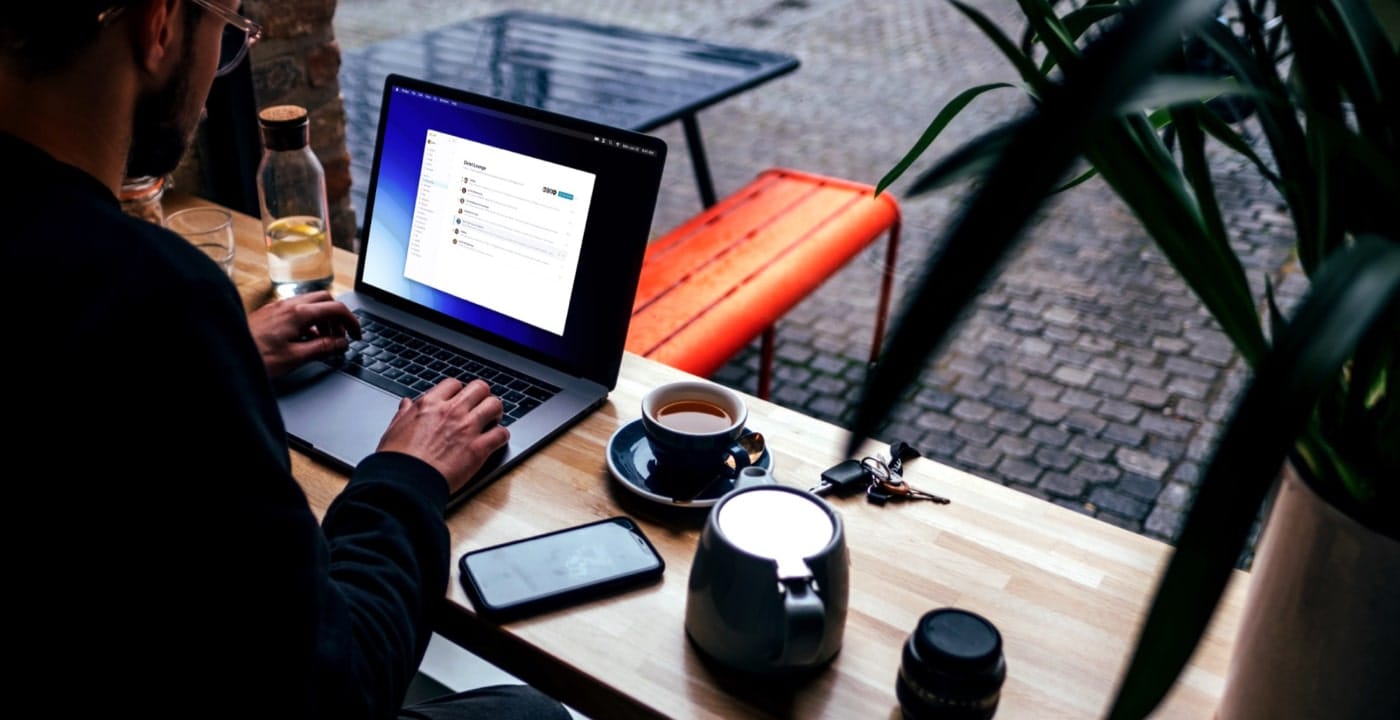 A man working on his laptop in a coffee shop